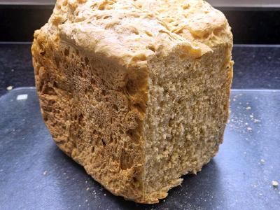Cheddar Cheese and Sunb Dried Tomato Loaf Tomato and cheese loaf with the cut end showing an open, slightly uneven crumb.