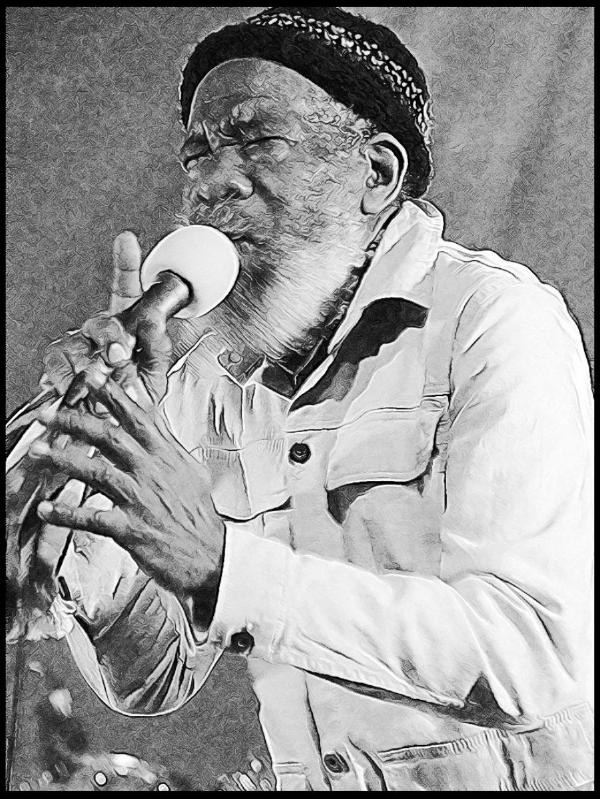Black and white stylized photograph of Walford &ldquo;Poko&rdquo; Tyson, performing with a microphone in an expressive pose. He wears a distinctive patterned headband and a light-colored button-up shirt while singing passionately during a live performance.