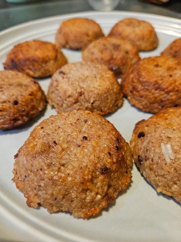 A plate of tasty looking home made shaped and baked date and almond rice balls
