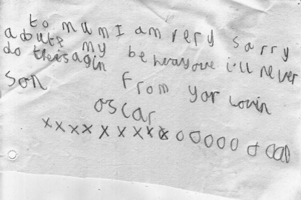 A handwritten note on lined paper with the message to Mum I am very sorry about my behaviour I&rsquo;ll never do it again from your loving son followed by multiple X marks and O marks representing kisses and hugs